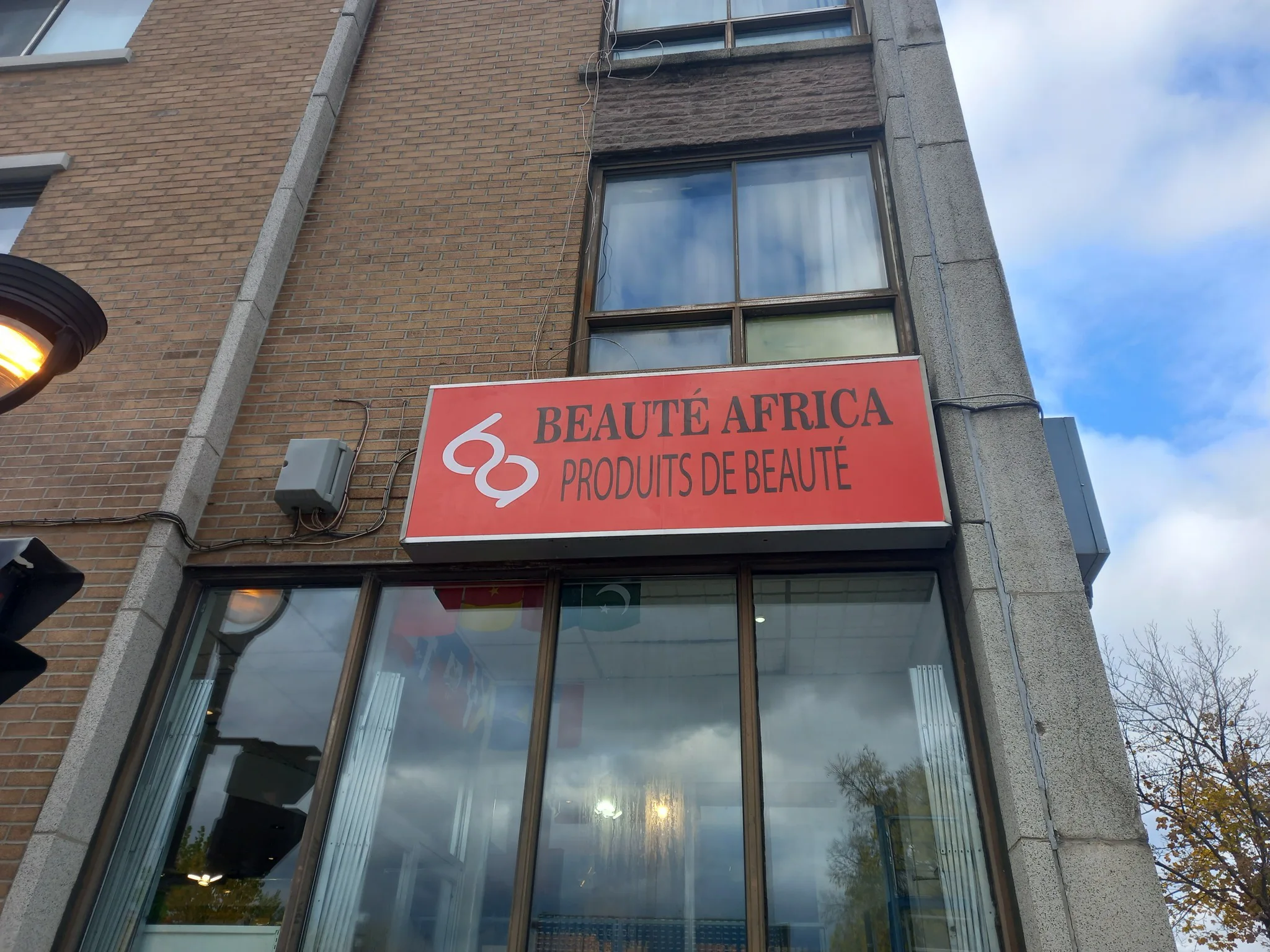 High-elevation commercial sign installation in Montreal using Max Printing in-house bucket truck fleet